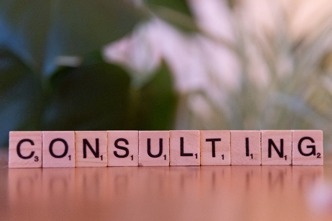 why-choose-us Wooden letter tiles spelling 'Consulting' with a blurred background. Ideal for business concepts.