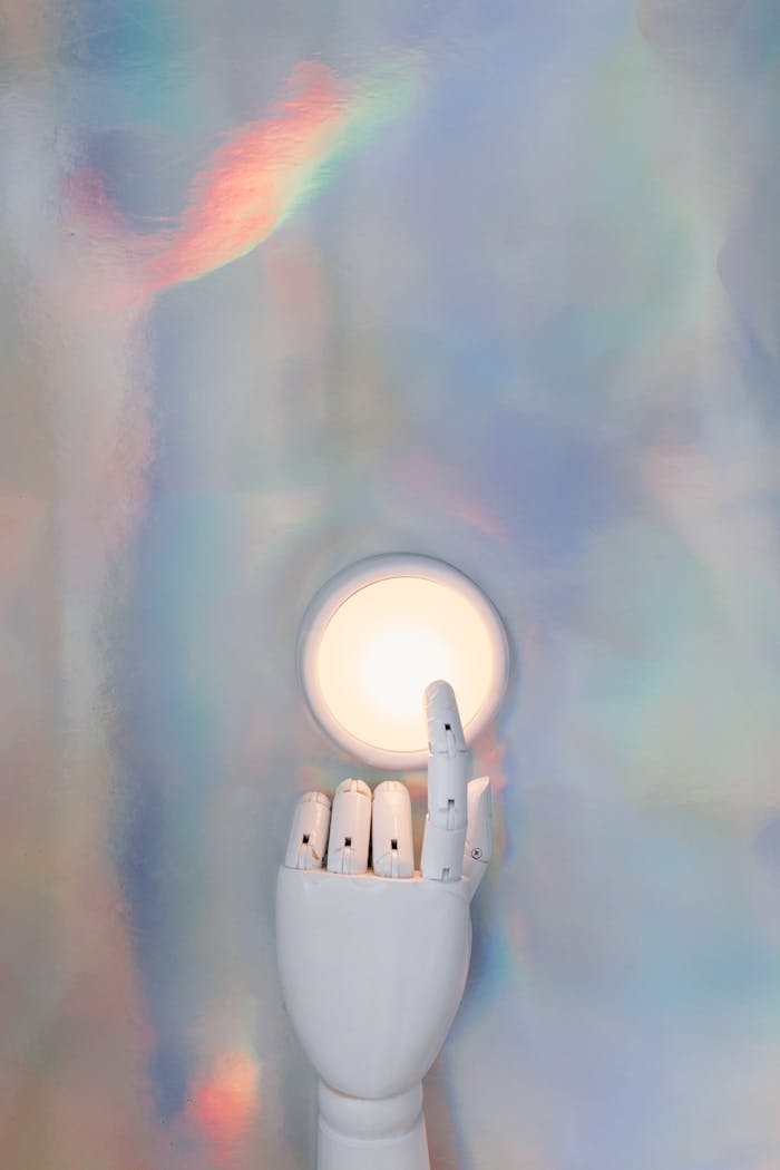 services-02 A robotic hand reaching towards a glowing circle on a pastel abstract background, hinting at advanced technology.